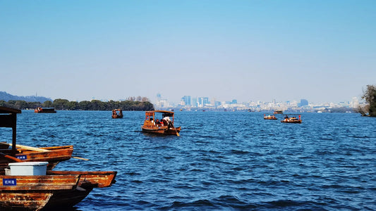 Tour boats on West Lake with the Hangzhou skyline behind – west lake hangzhou